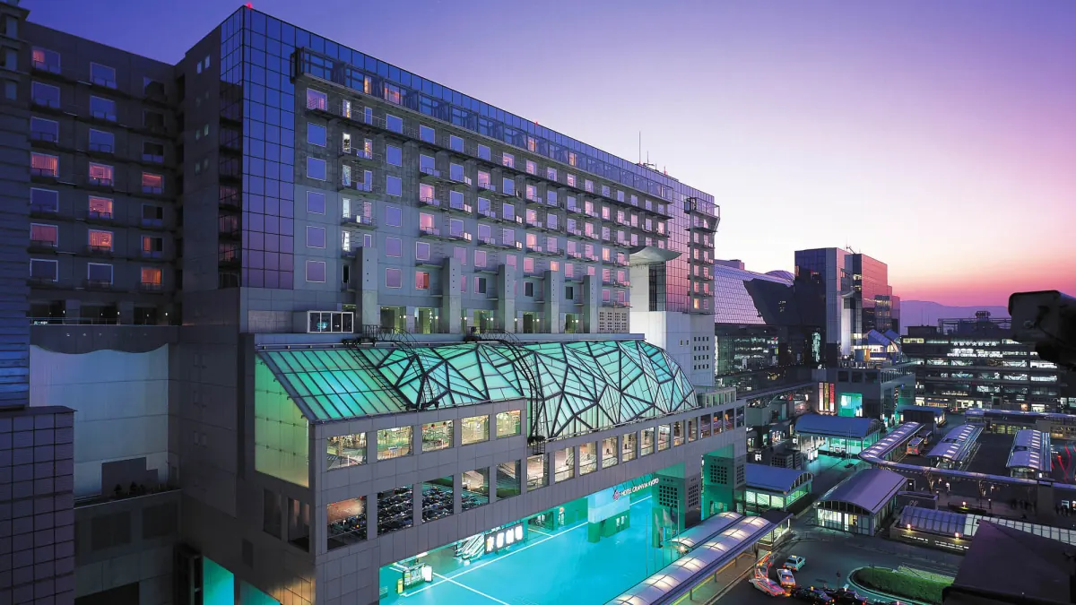Hotel Granvia Kyoto at dusk, its facade rising above the glass-roofed Kyoto Station concourse